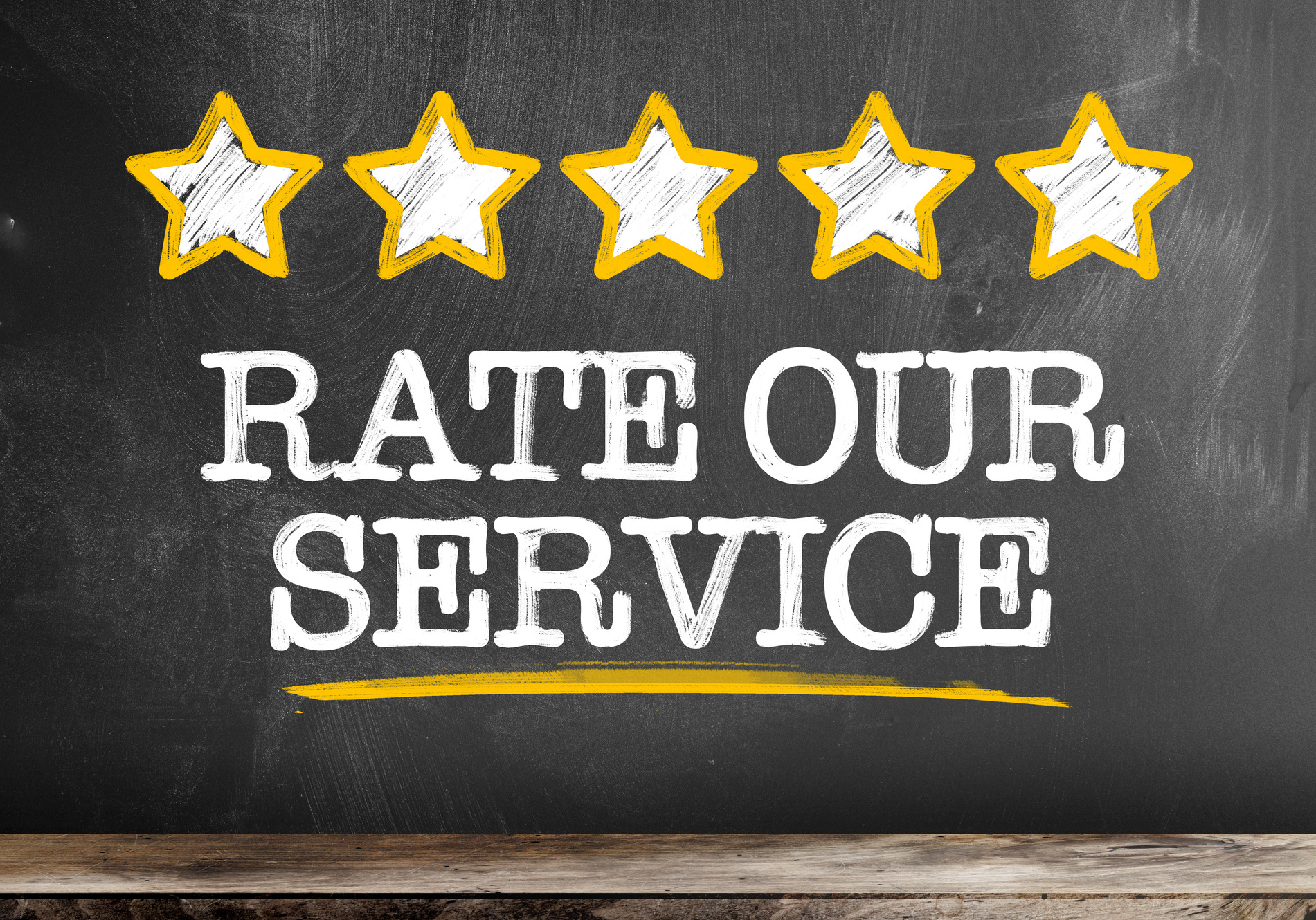 text RATE OUR SERVICE written on blackboard with five golden stars